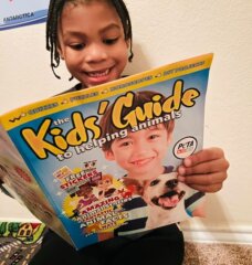 little boy reading a magazine