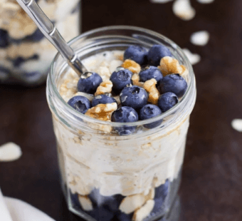 overnight oats in a mason jar with granola and blueberries